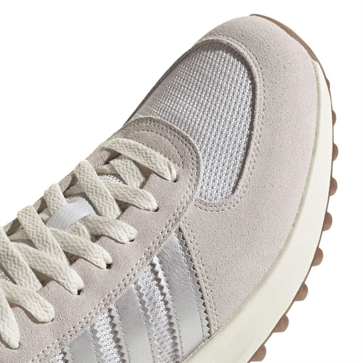 Close-up of adidas Trainer Lux upper with grey mesh, suede panels, and white laces
