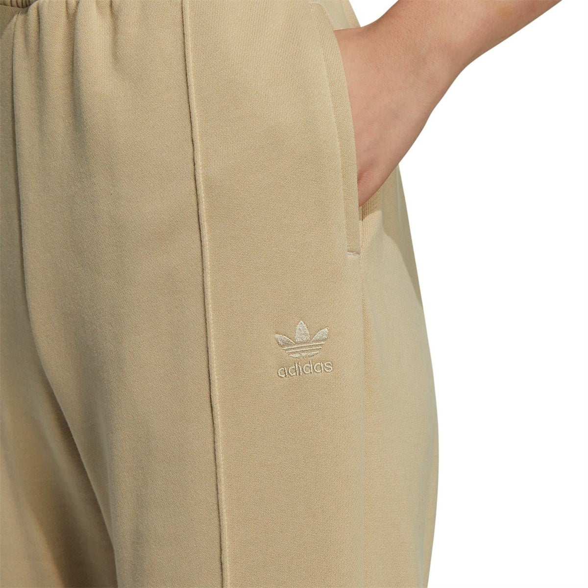 Beige adidas Originals sweatpants with small adidas trefoil logo and stitched seams