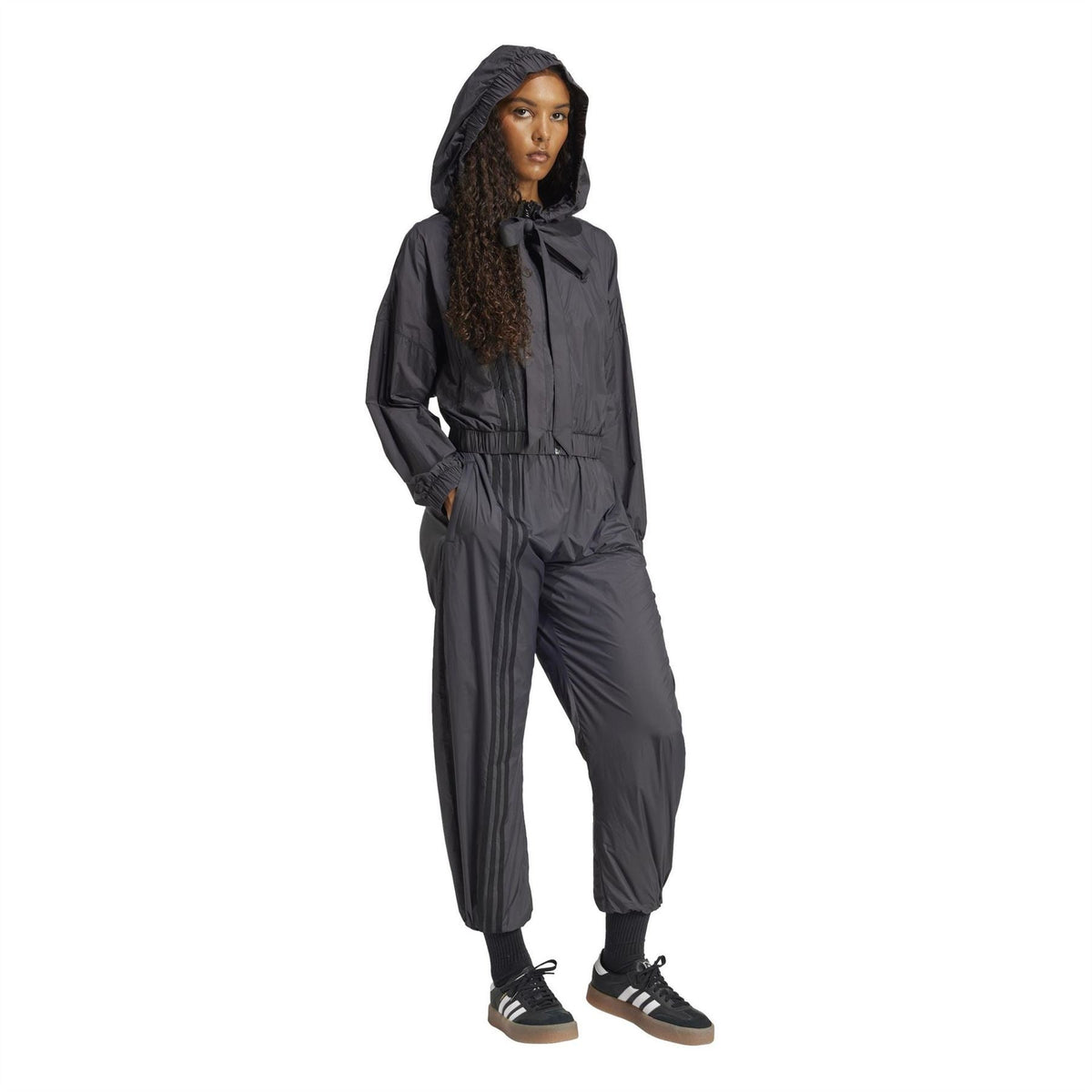 Black hooded bomber jacket styled with drawstring waist and bow-tie collar