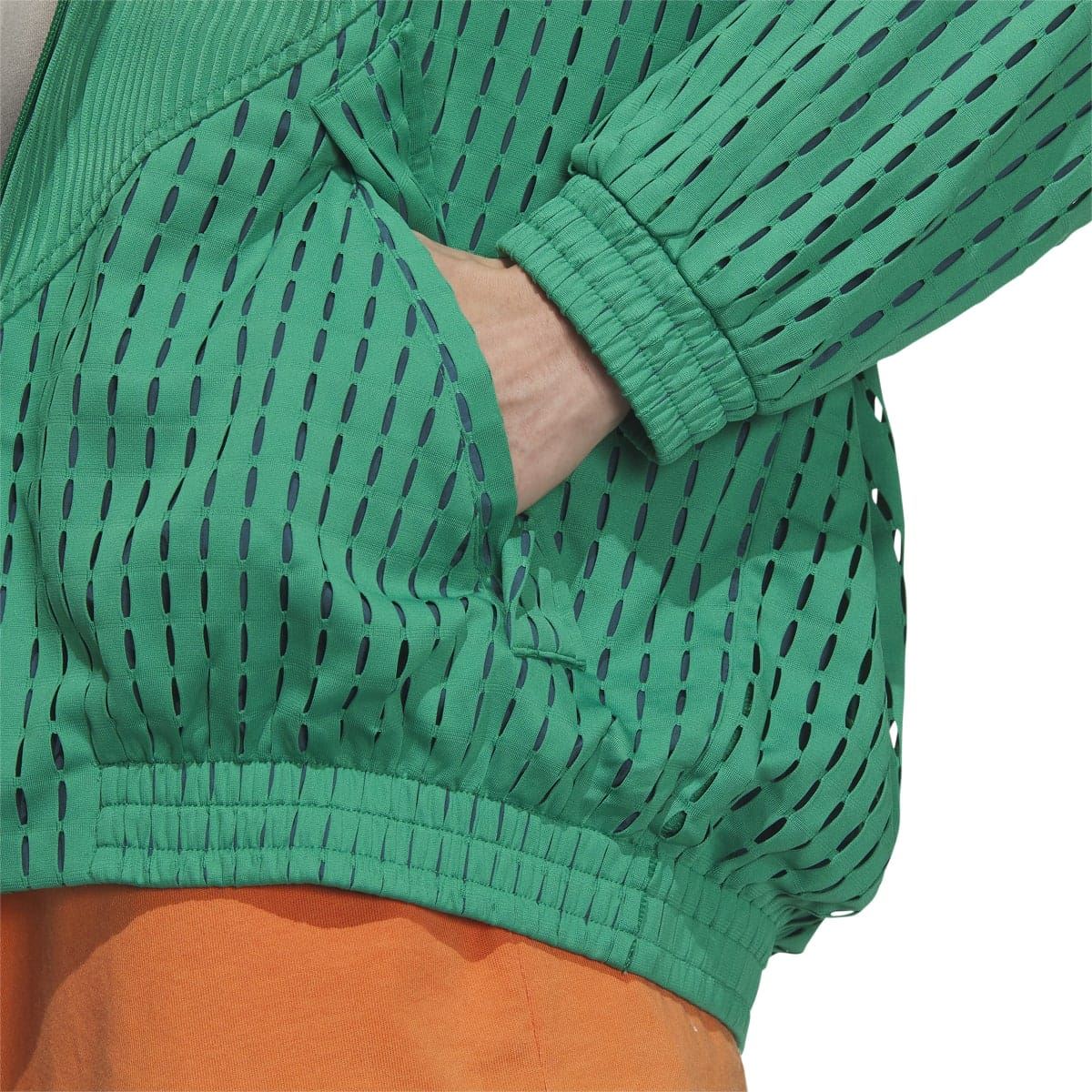 Green jacket sleeve close-up with perforated knit pattern and elastic ribbed cuff