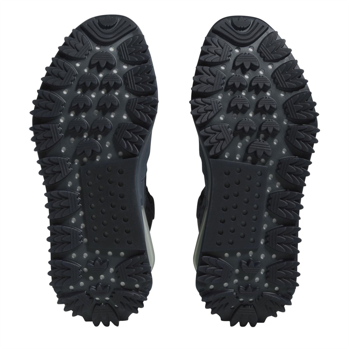 Bottom view of dark blue sneaker outsole with rugged traction lugs and tread pattern.