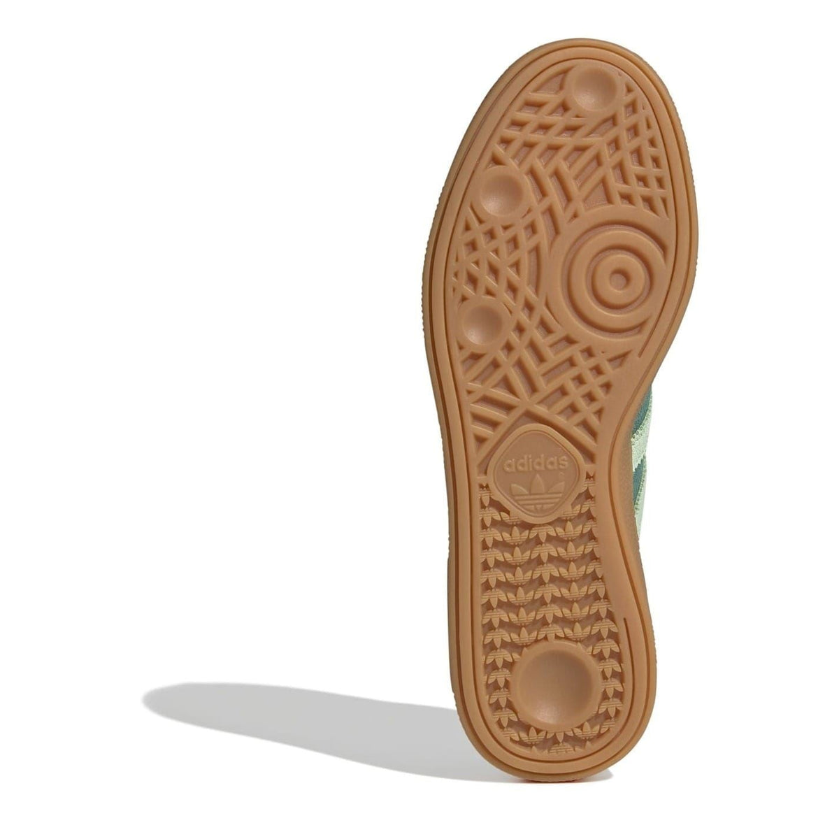 Gum rubber outsole for green low-top sneakers with tread pattern