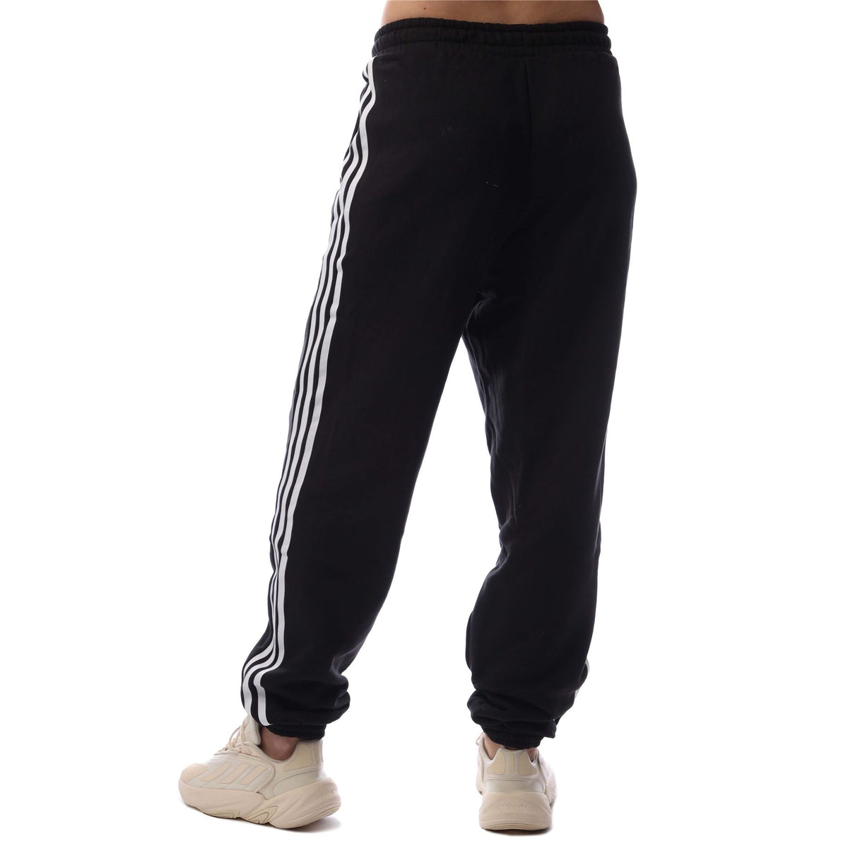 adidas Originals black jogger pants with three white side stripes, tapered leg