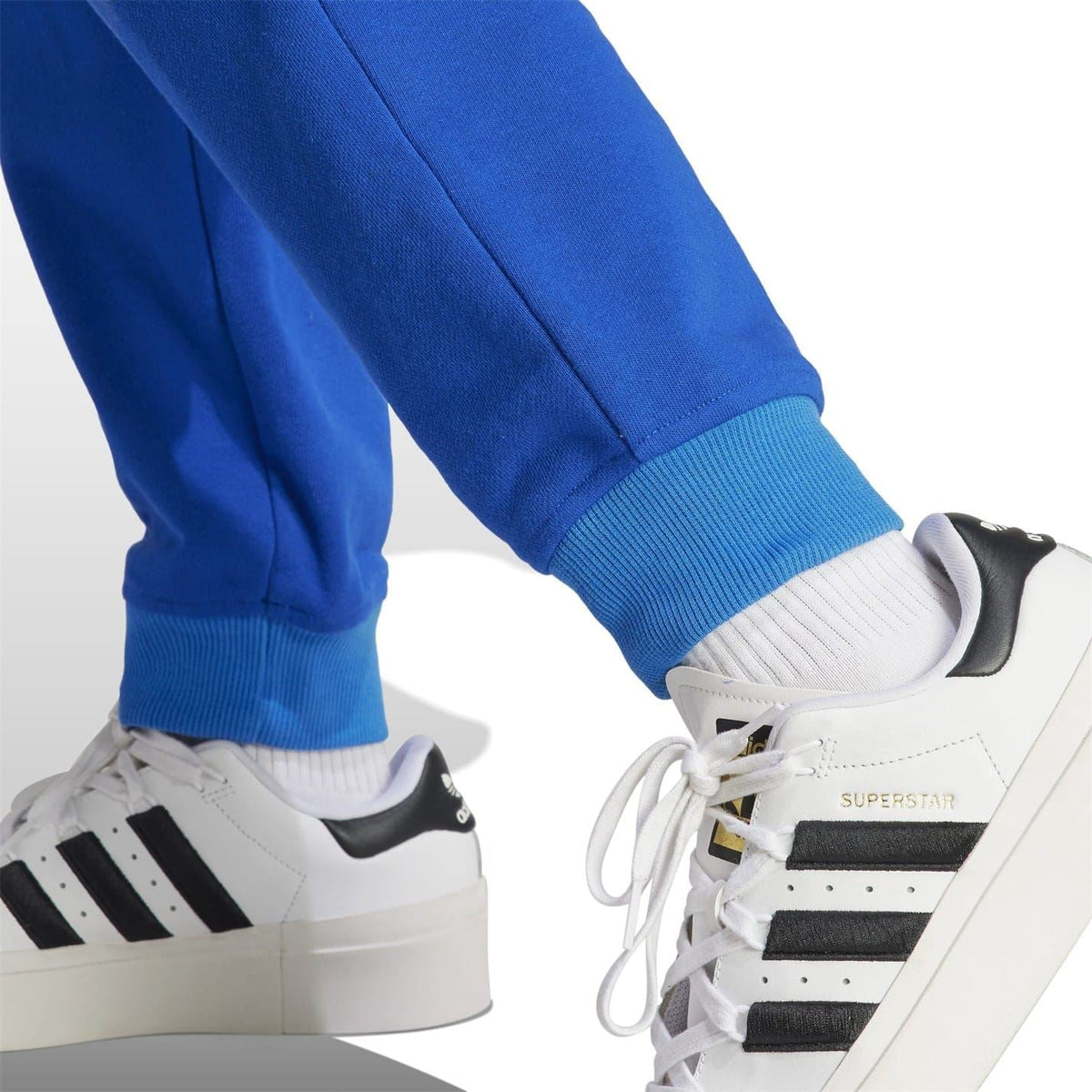 Adidas Originals casual sweatpants with tapered fit, soft fabric, and iconic branding, designed for comfort and everyday wear.