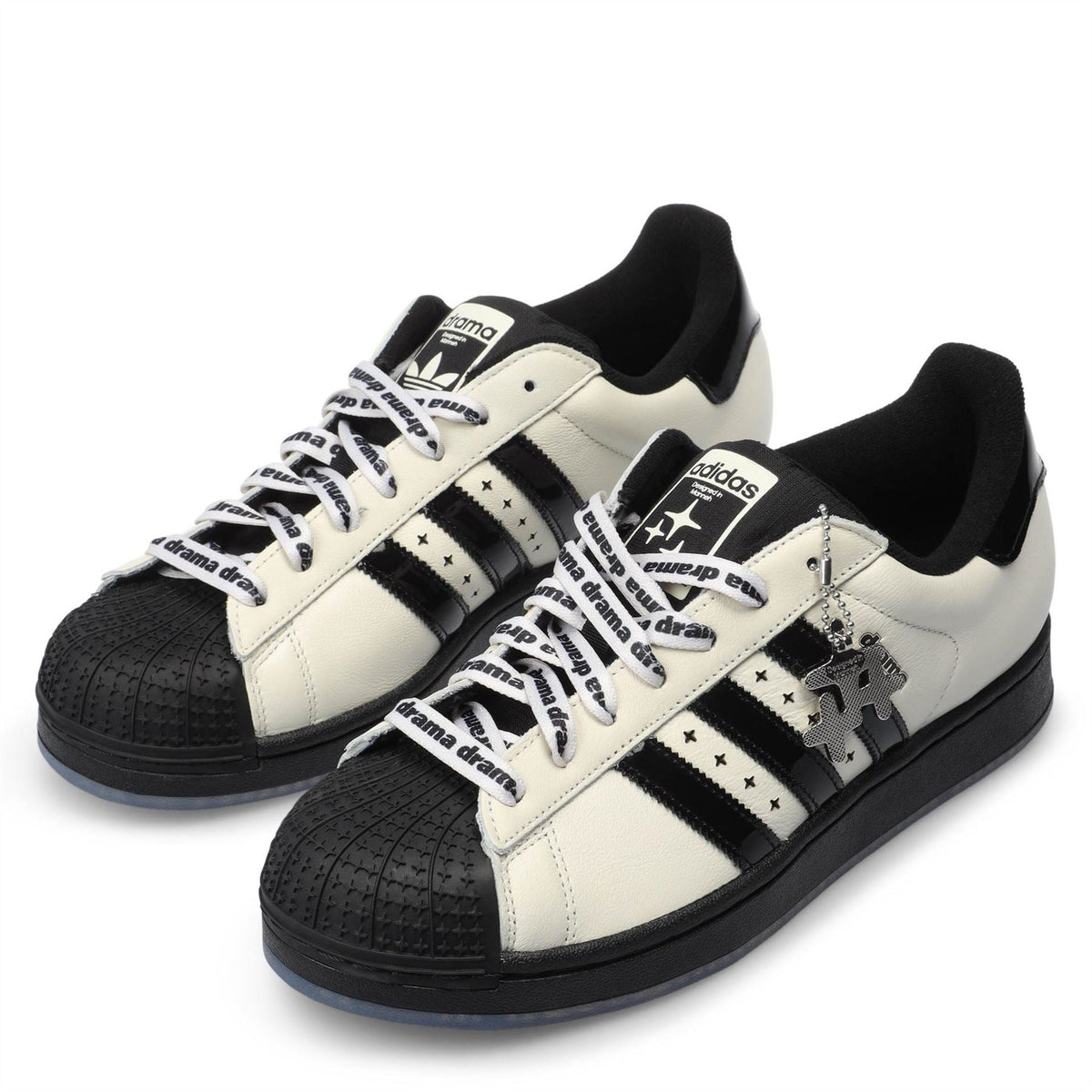 adidas low-top sneakers in off-white with black toe cap, lace-up, and star patch