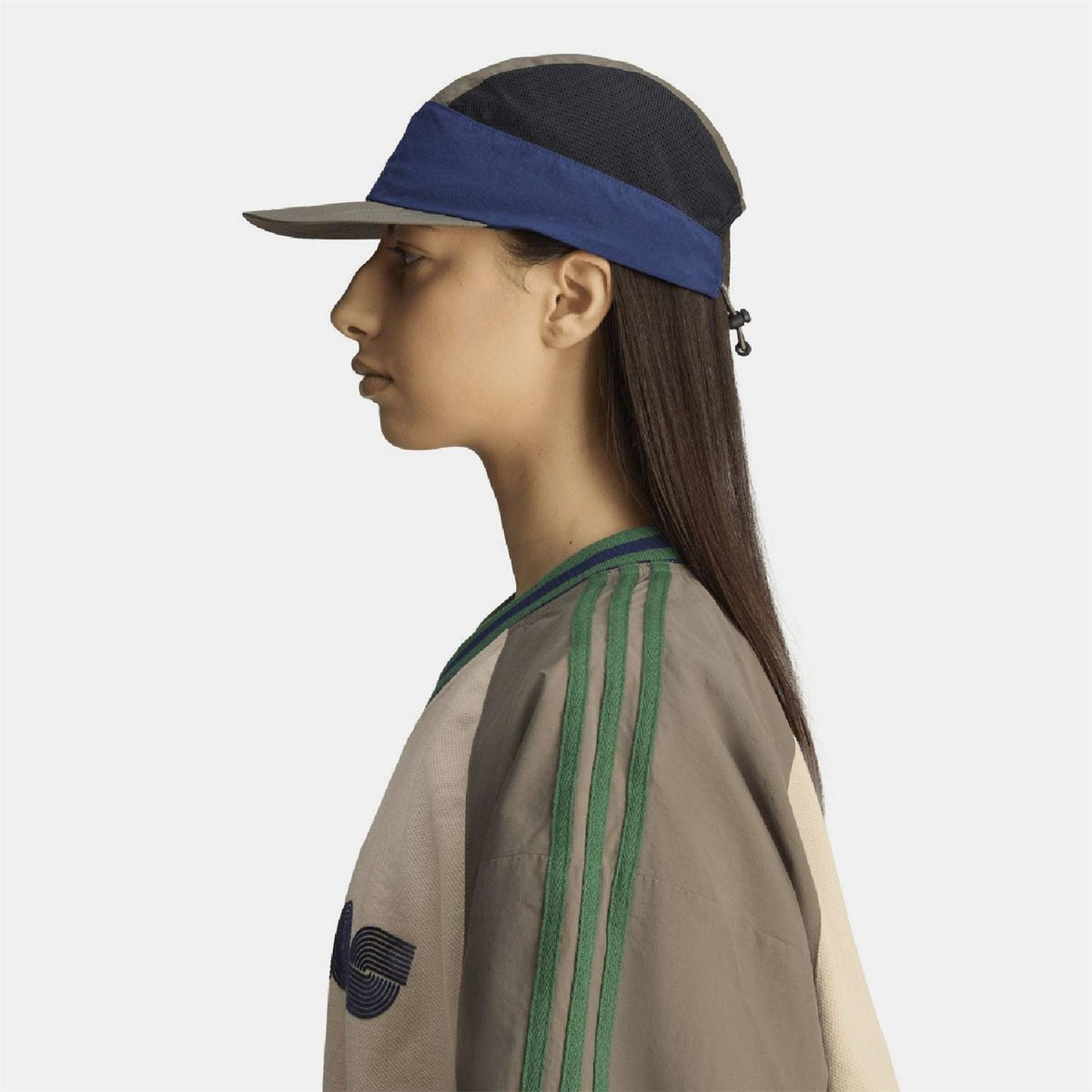 Side view of adidas cap with olive panels, blue band, and curved brim