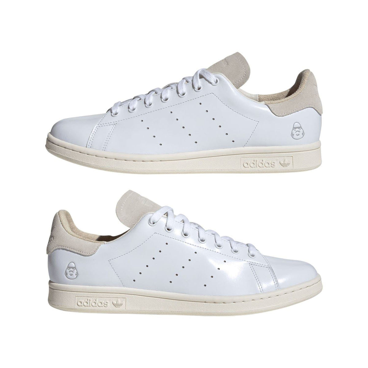 Pair of white adidas trainers with beige suede collar, lace-up and perforated details