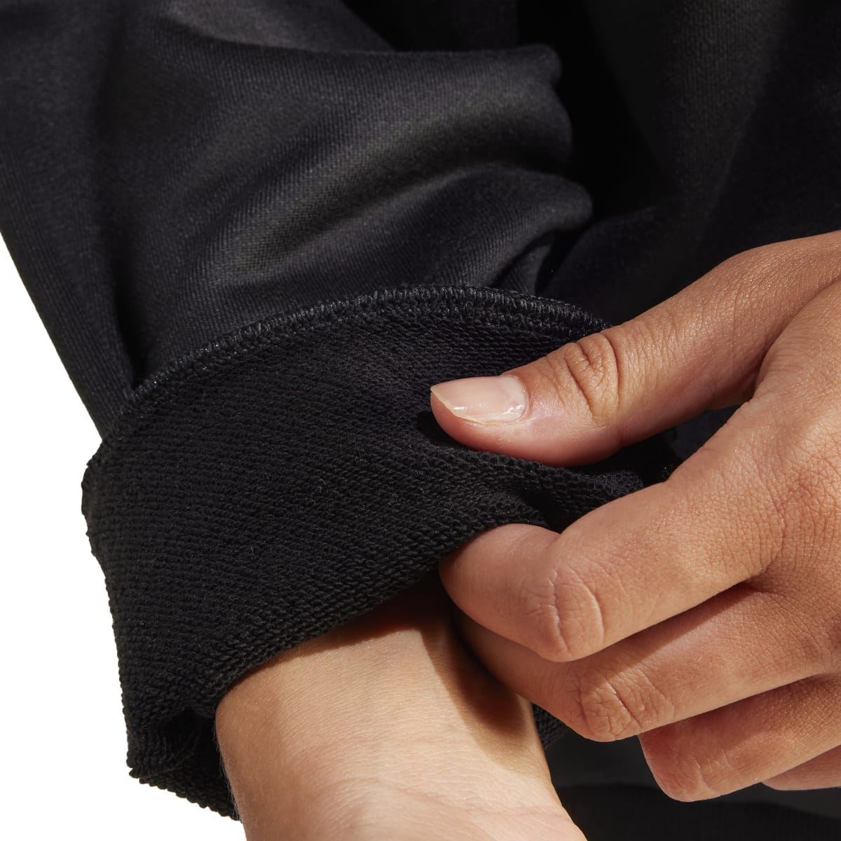 Close-up of black sweatshirt cuff and hem fabric with ribbed knit texture