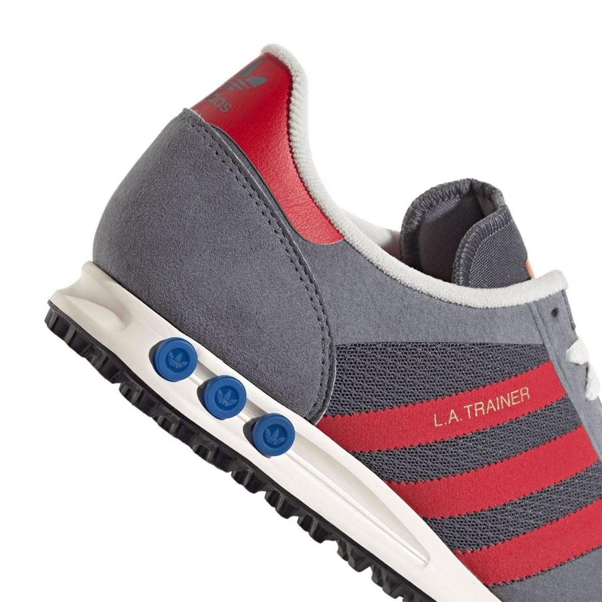 Grey adidas trainer with red stripes and blue traction pods on white midsole