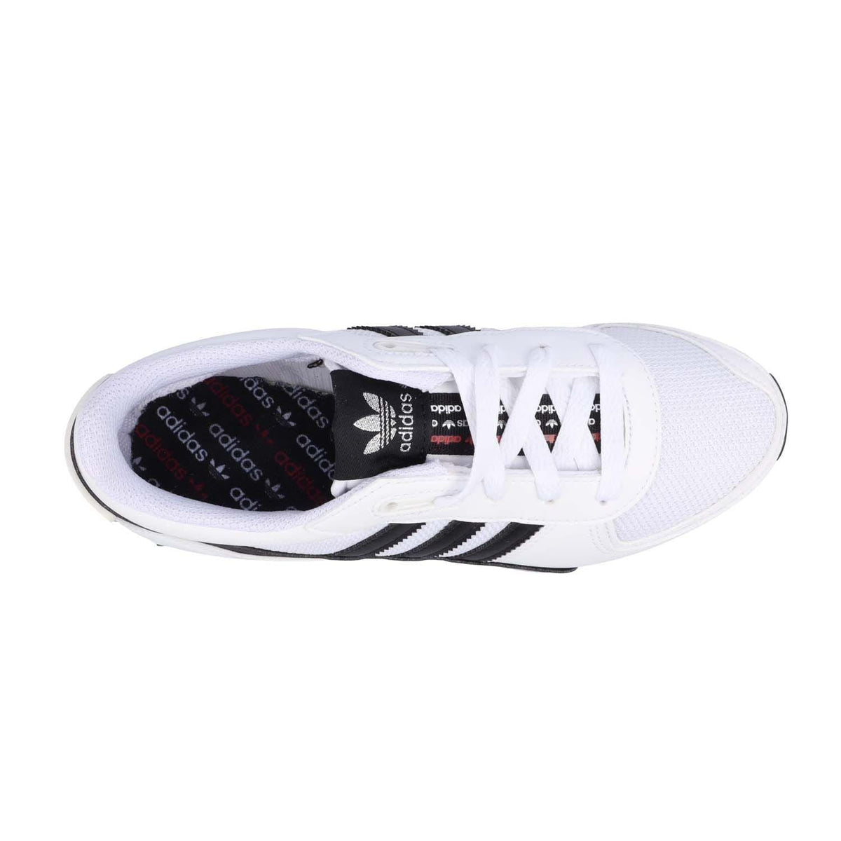 White junior Adidas sneakers showing laces and black three stripe branding inside.