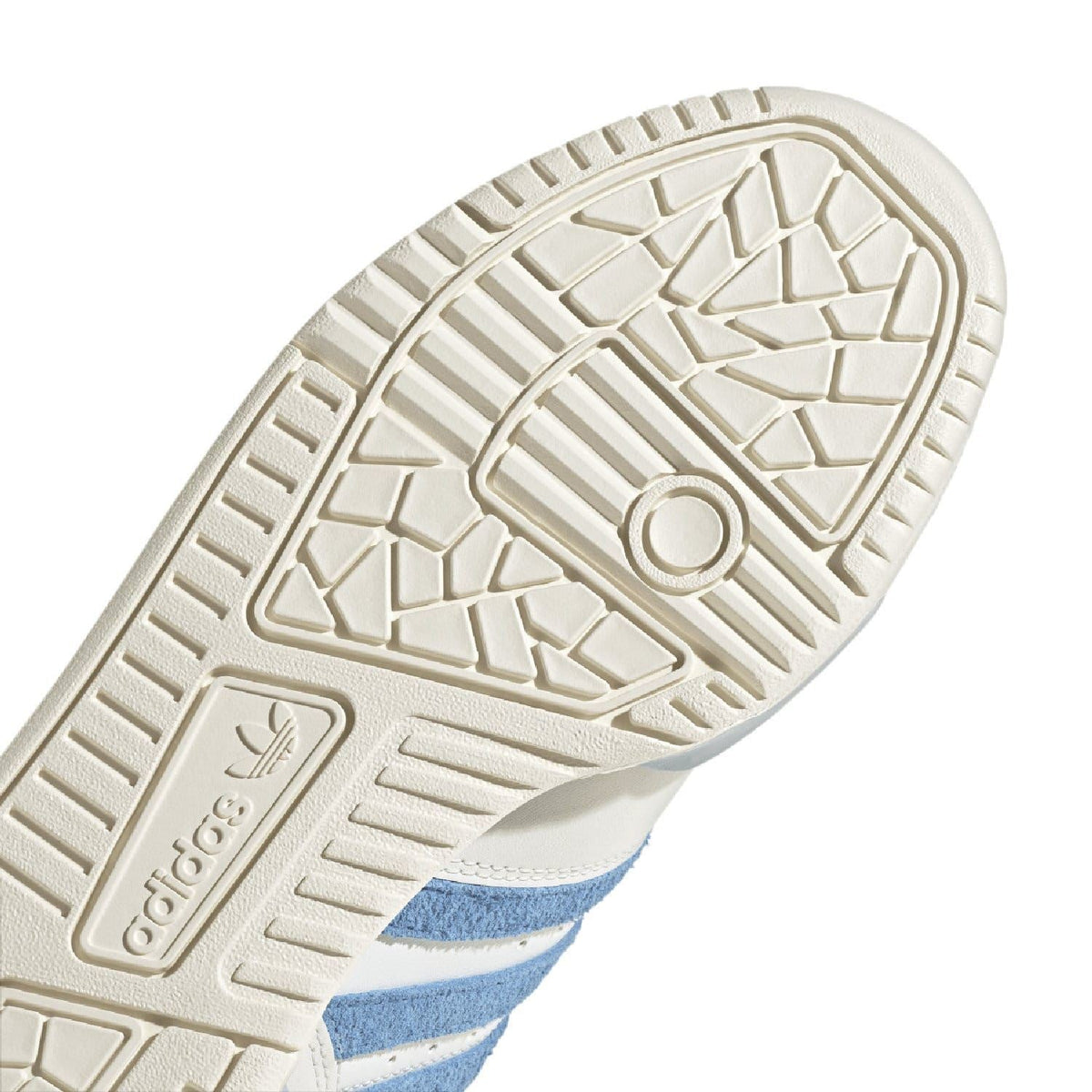 Close-up white rubber outsole tread with adidas logo and blue sidewall edge