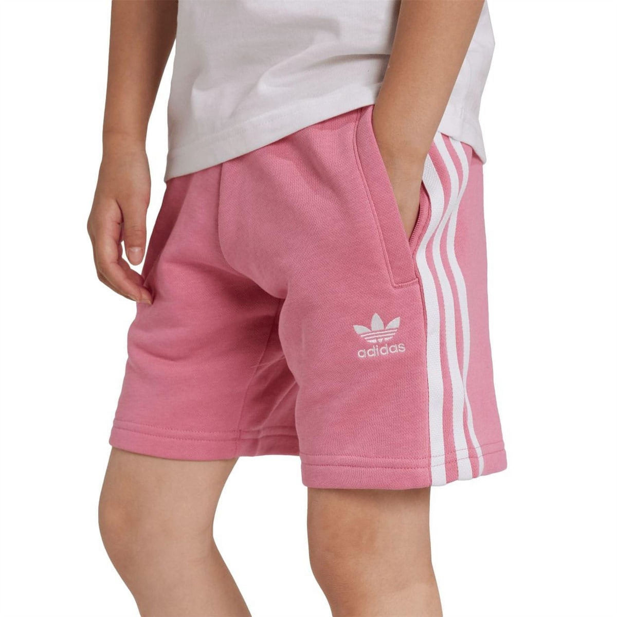 Close-up: rose adidas shorts with side stripes and trefoil logo, with white tee