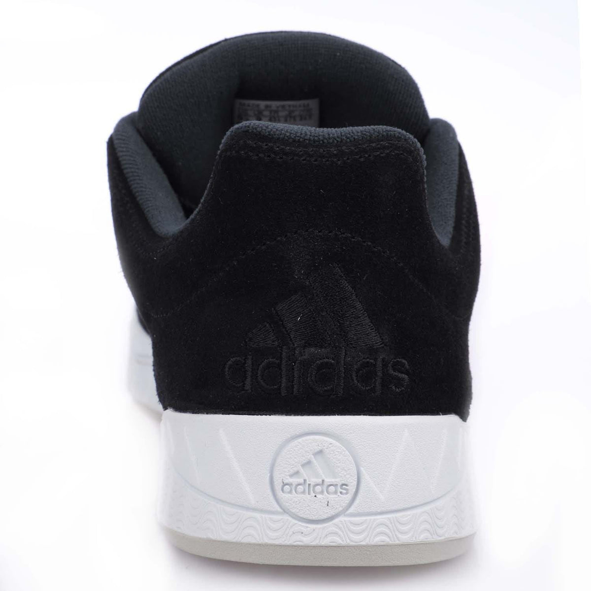 Back view of black adidas Originals Adimatic trainers with embossed adidas on heel and white sole