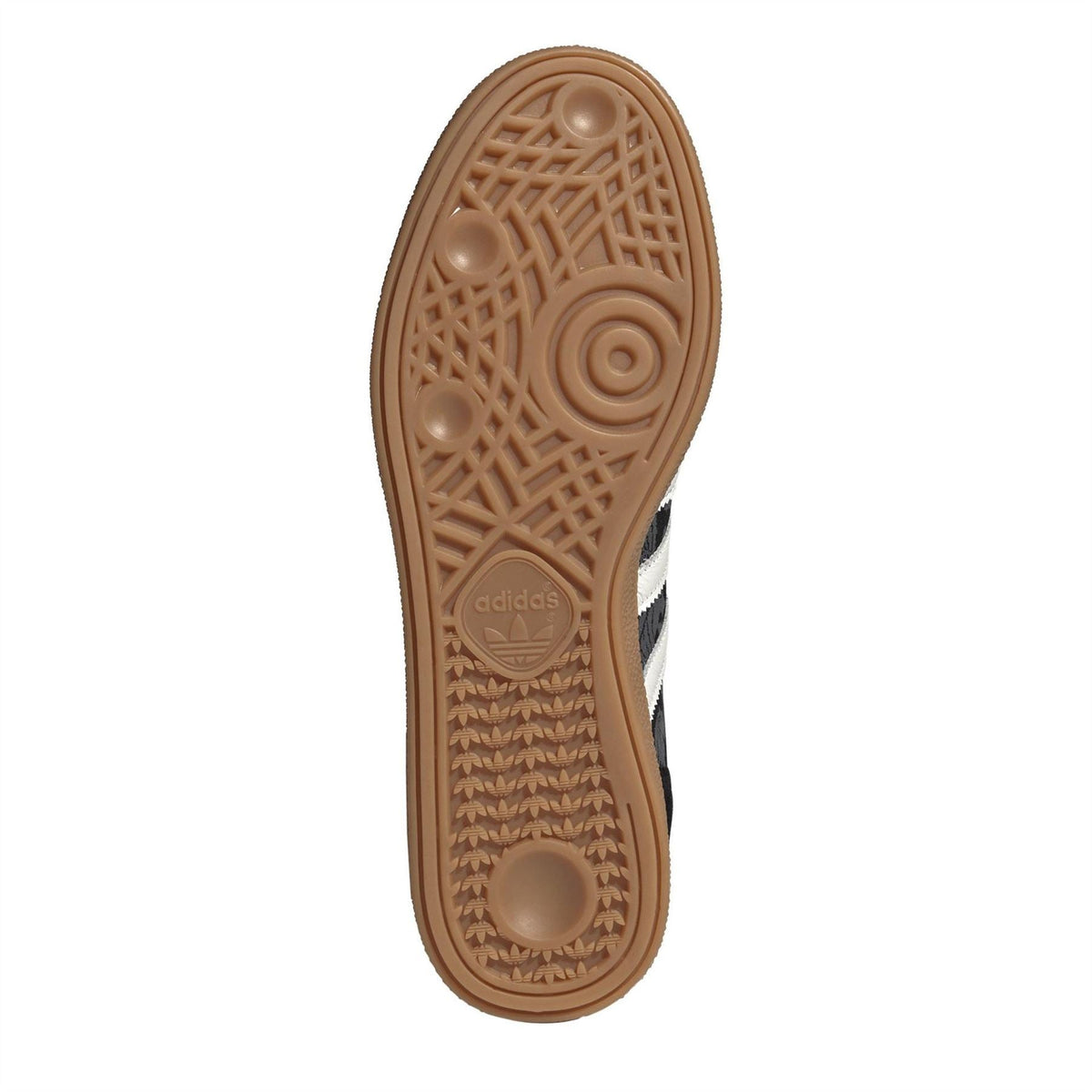 Gum outsole bottom view of a black low-top adidas trainer with textured tread