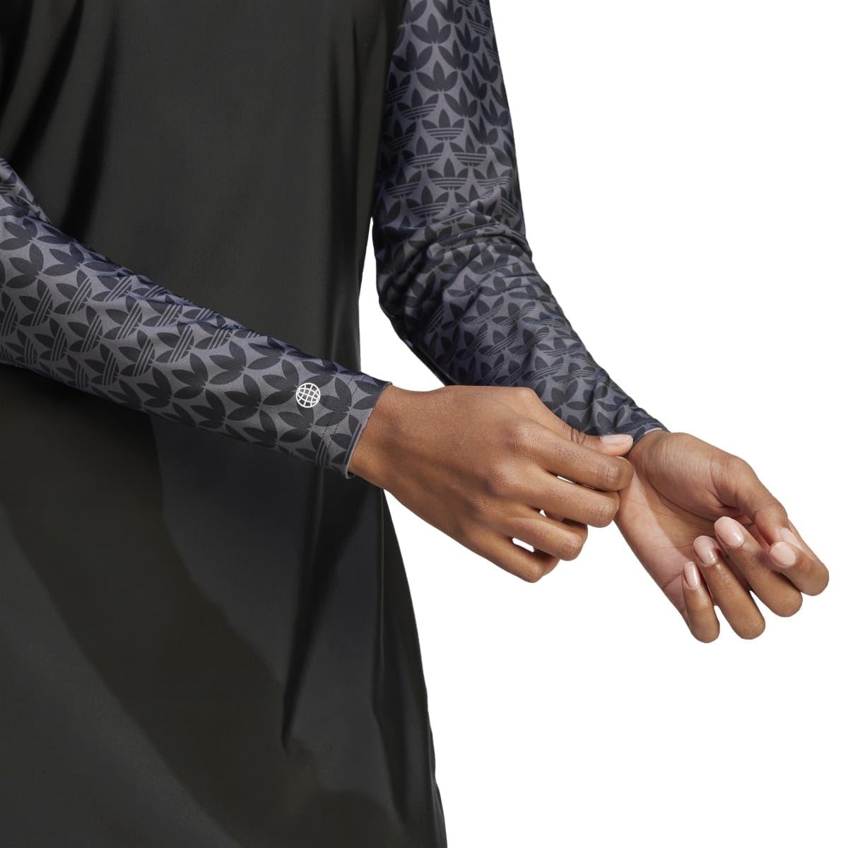 Black swim top sleeve with monogram pattern and thumb-loop cuff