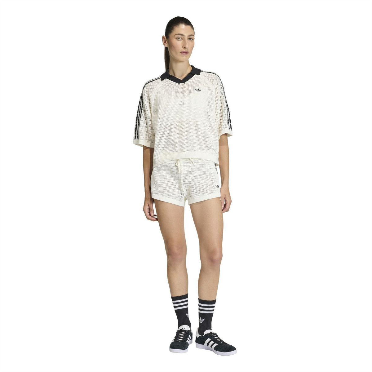 Off-white short-sleeve polo shirt with black collar and adidas trefoil, model wear
