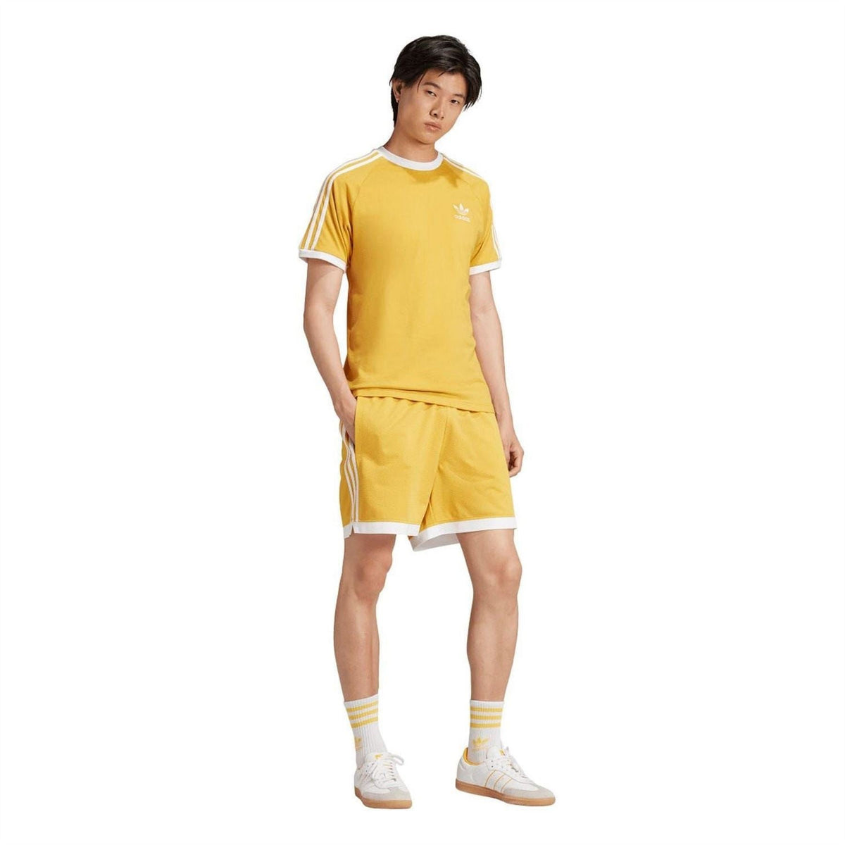 Yellow adidas Originals T-shirt with white 3-stripe sleeves, worn with matching shorts