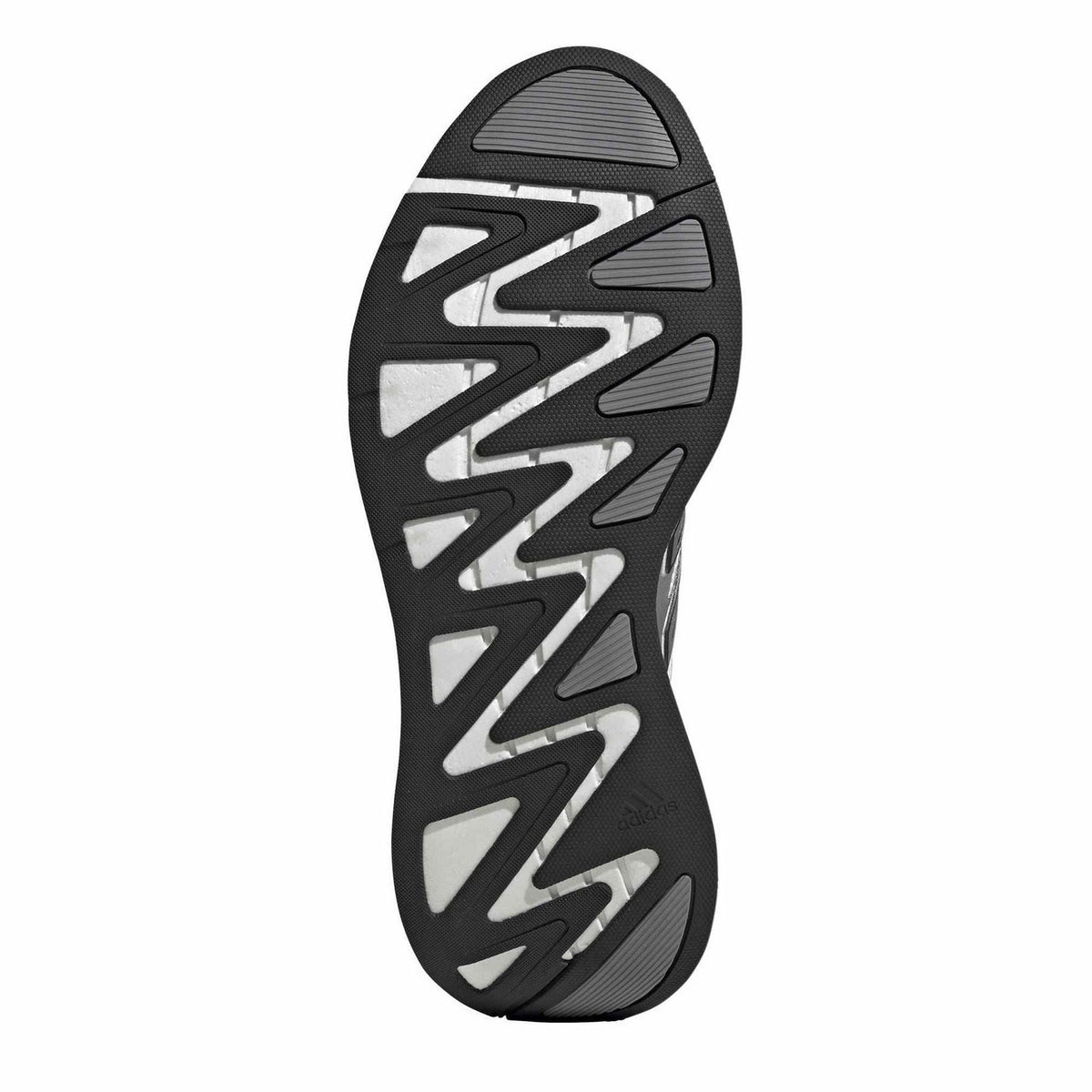 Rubber outsole for a silver and white running shoe with multi-direction traction pattern.