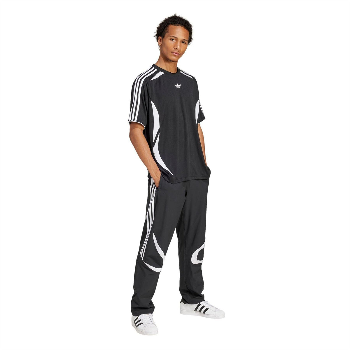Black adidas Originals Teamgeist tee with white stripes, worn with matching track pants