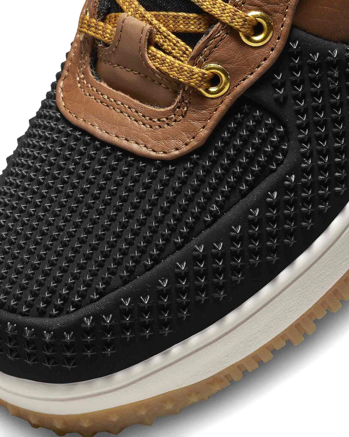 Men's Nike duckboot close-up of black textured side panel and brown lace tab
