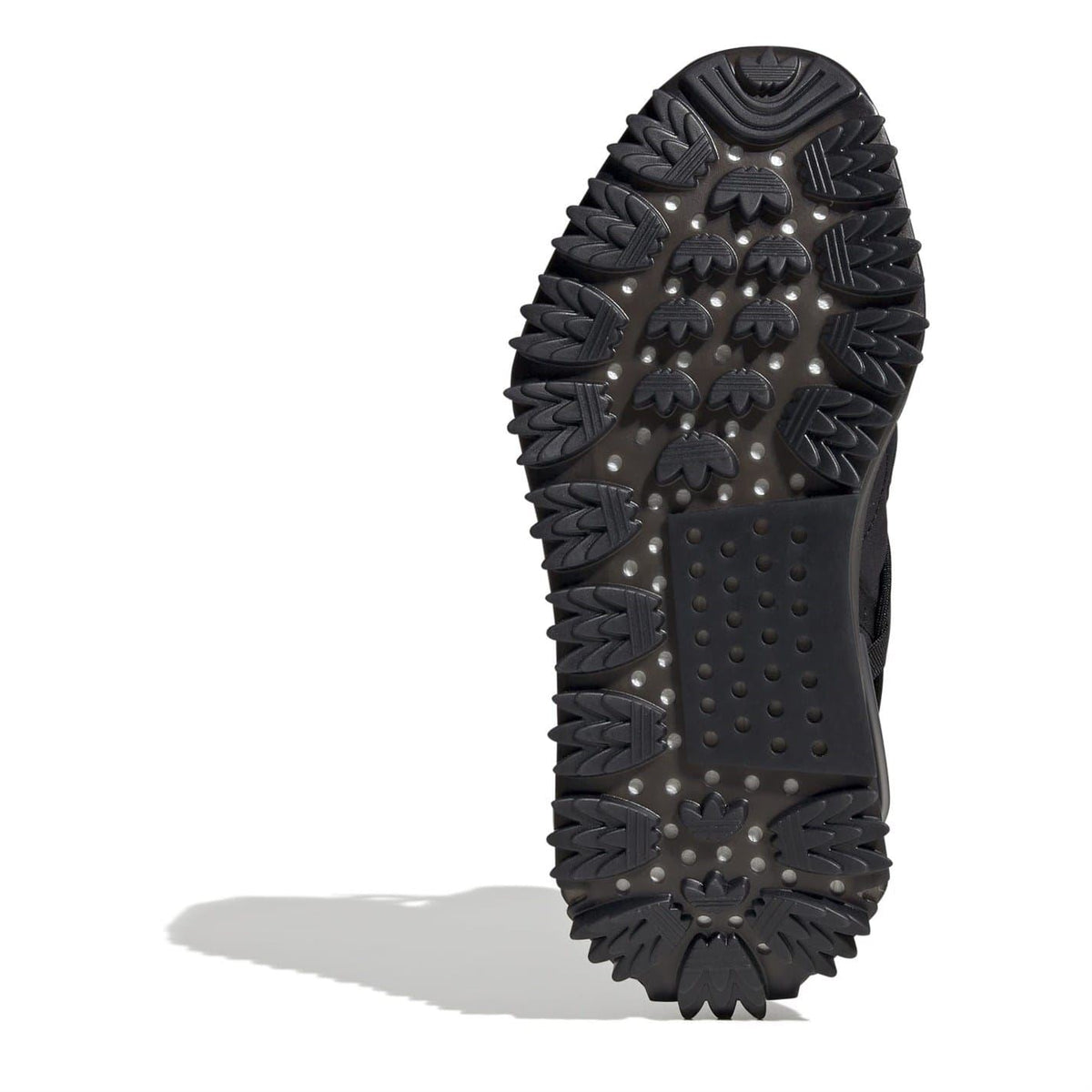 Black Adidas boot outsole with spike-like tread and dotted traction pods.