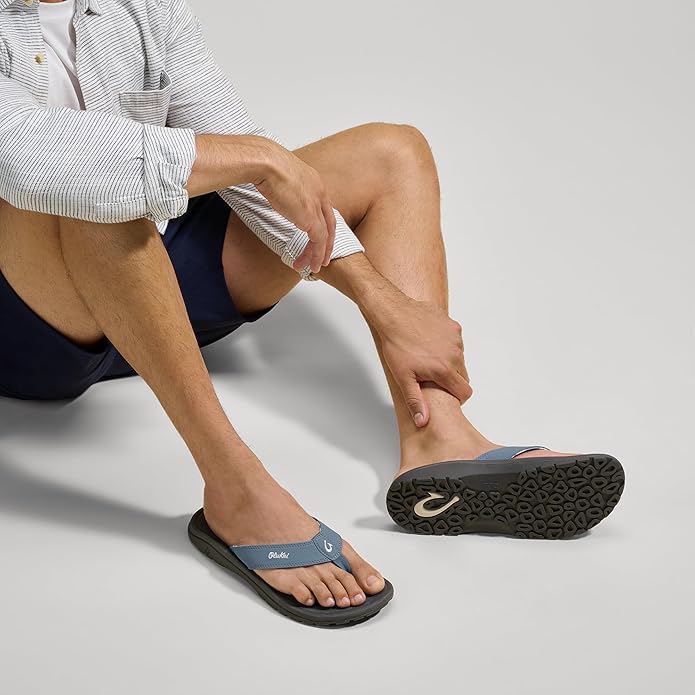 Blue flip-flop sandals with black outsole tread and logo strap