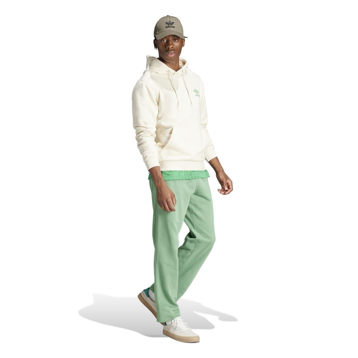 Cream adidas Originals graphic hoodie worn with green pants; front pocket and hood