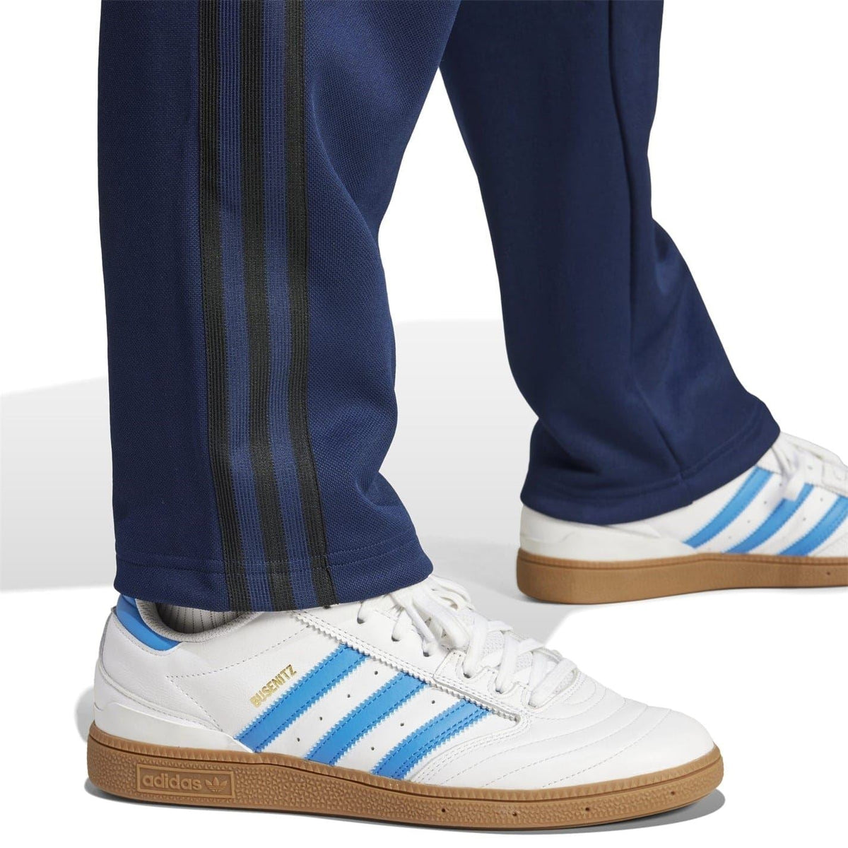 Navy blue joggers showing side stripe panel and cuffed ankle hem