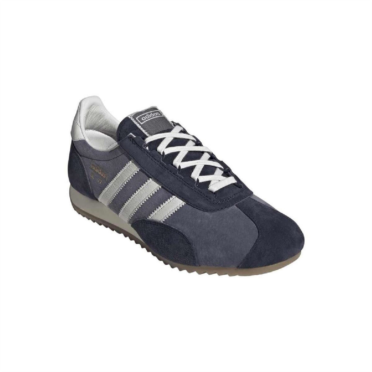 Navy suede trainers with white laces, white stripes, and leather heel panel