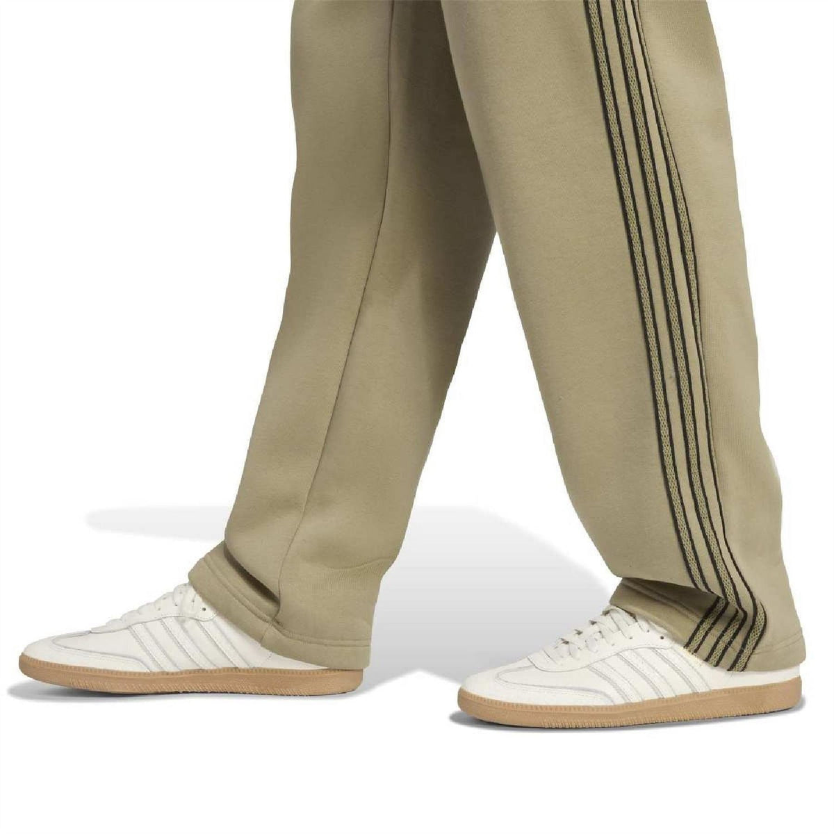 Olive-green joggers with dark side stripe bands, paired with white sneakers