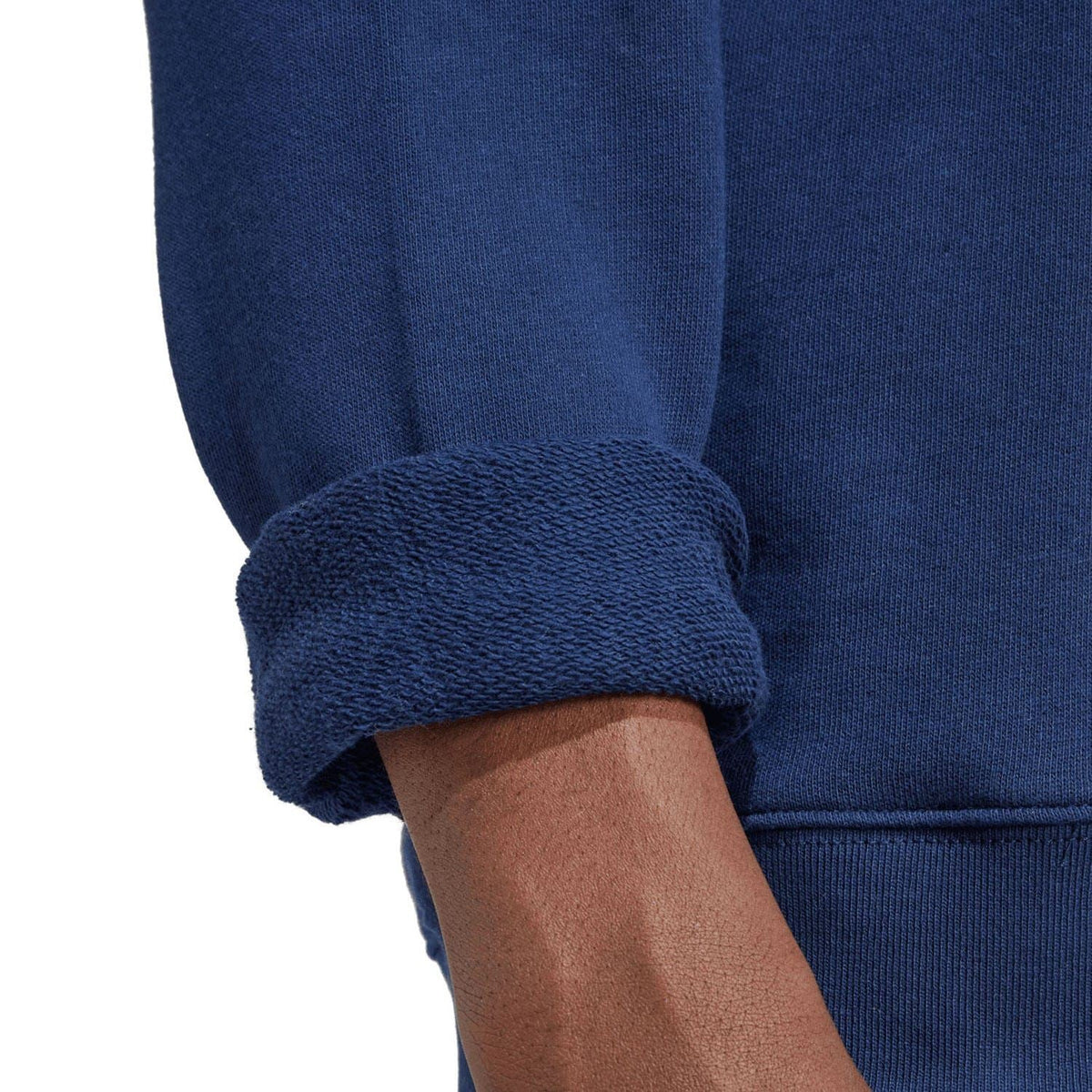 Indigo sweatshirt sleeve cuff close-up with ribbed knit detail