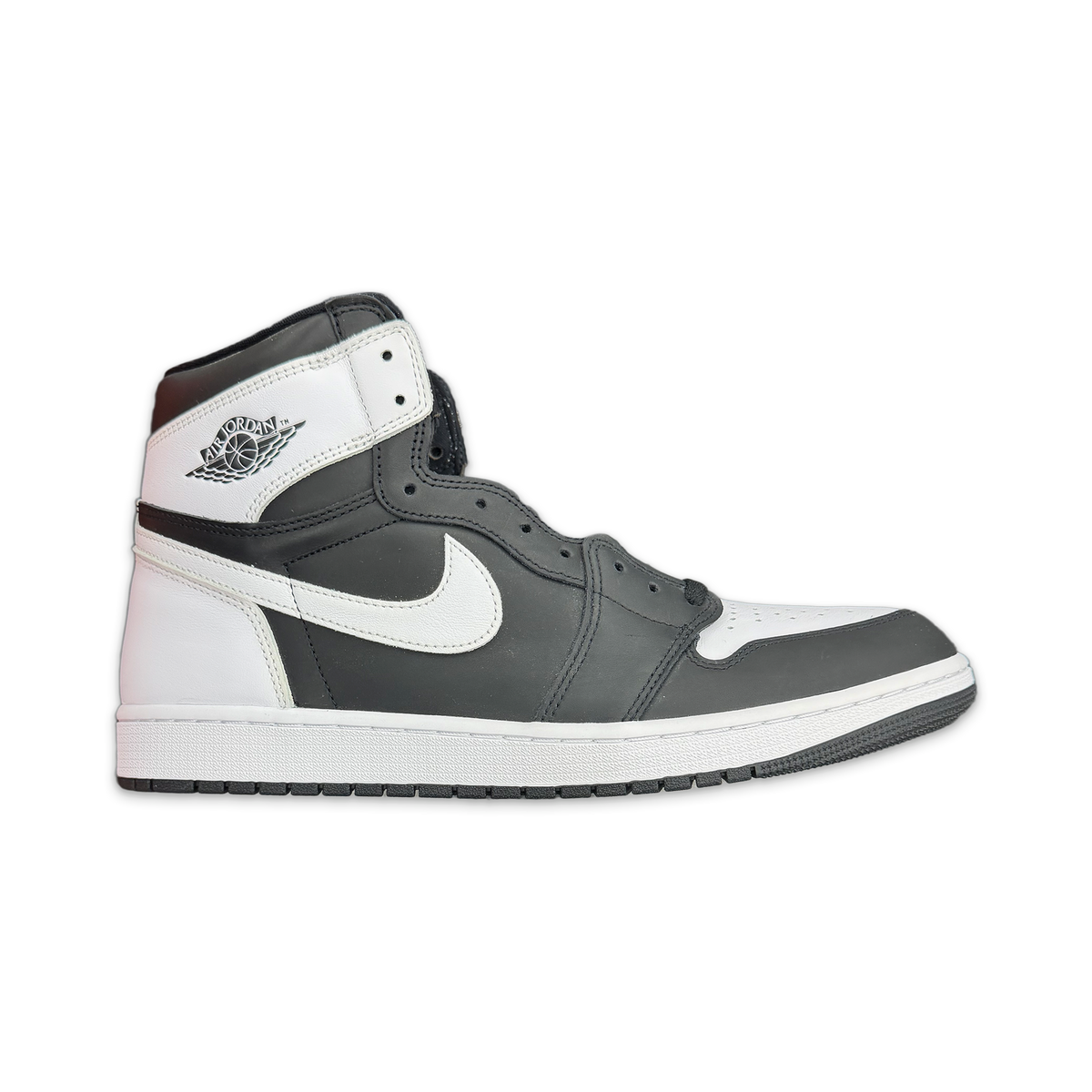 Air Jordan 1 Retro High OG high-top sneaker in black and white leather with swoosh