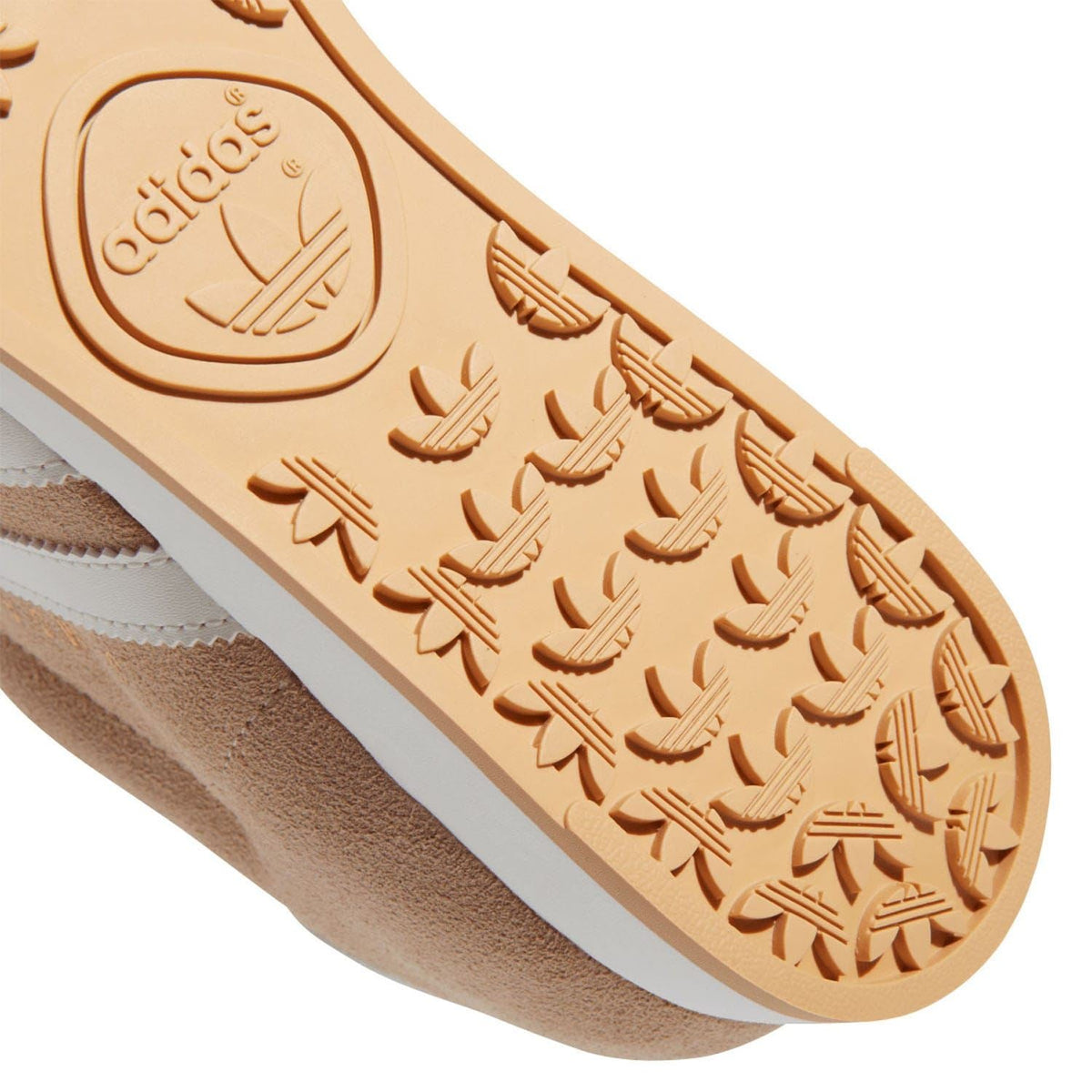 Close-up beige adidas Samoa outsole tread with repeating shoe-shaped pattern