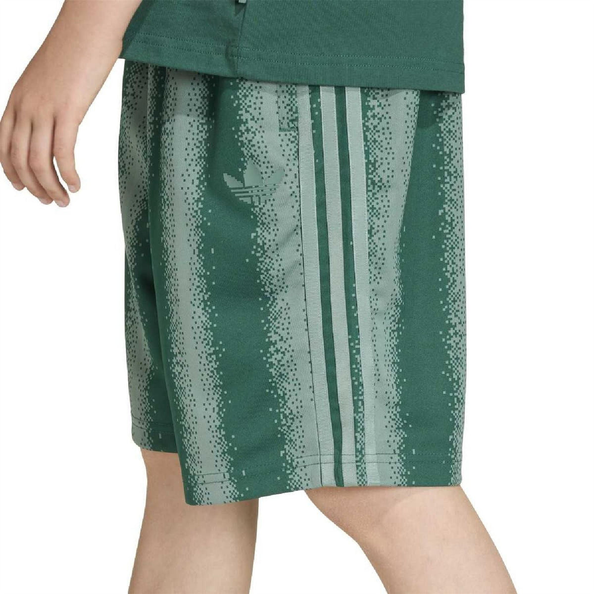 Green speckle-print shorts close-up with three vertical stripe accents