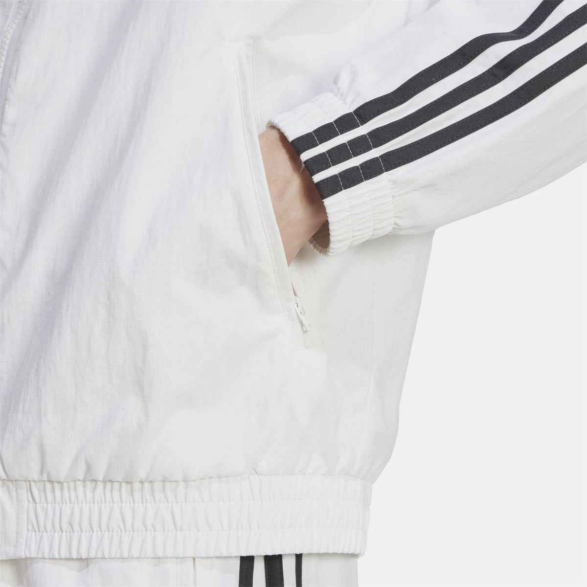adidas Originals woven Firebird track top in black with colorful stripes, featuring zip-up front and ribbed cuffs and collar.
