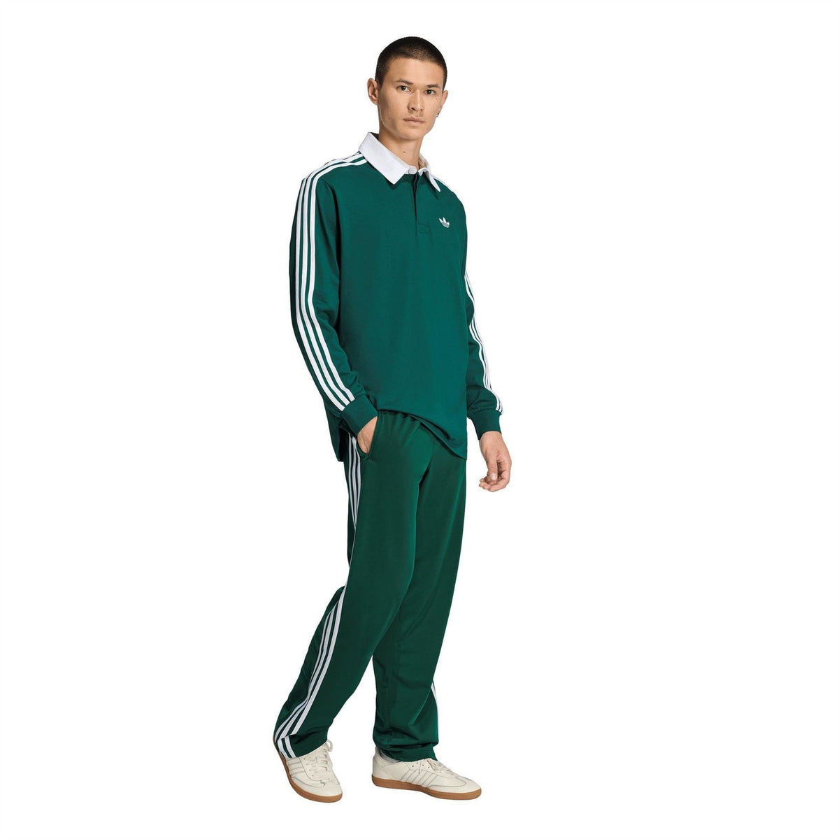 Men's dark green adidas track joggers with white side stripes and tapered open hem