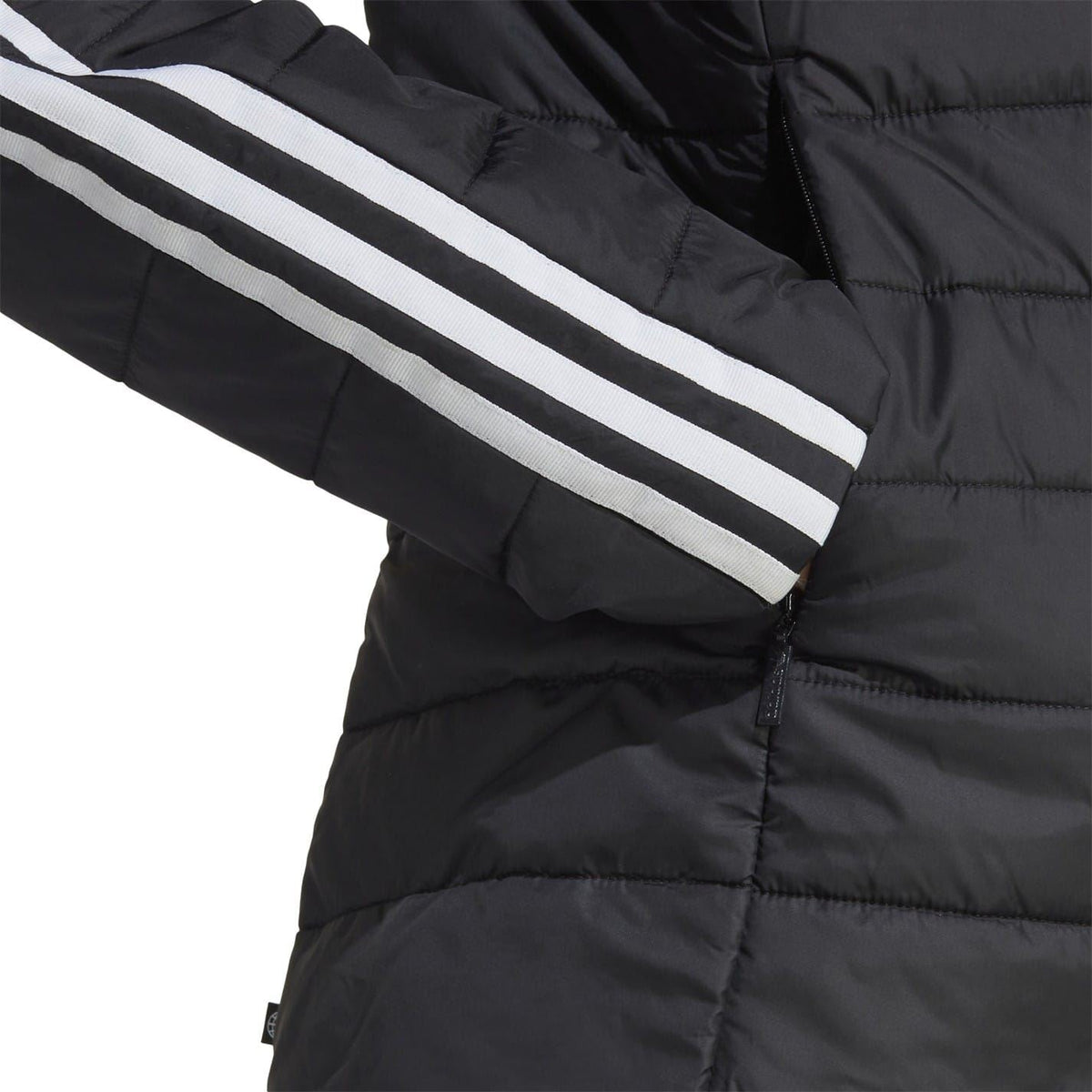 Black puffer jacket sleeve detail with three white stripes and quilted stitching