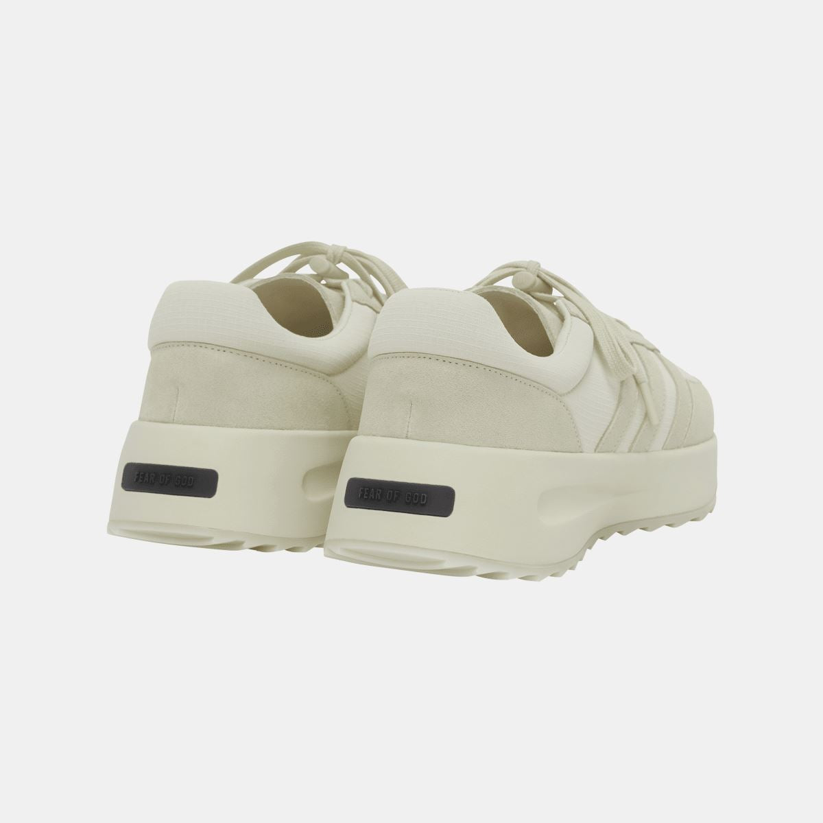 Cream trainers rear view with heel branding tab and chunky midsole