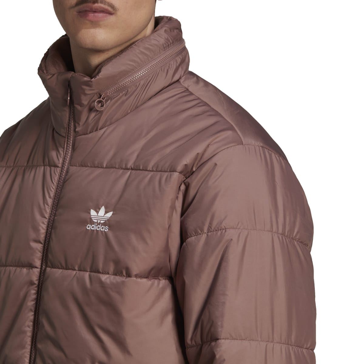 Burgundy padded puffer jacket chest close-up with Adidas trefoil logo