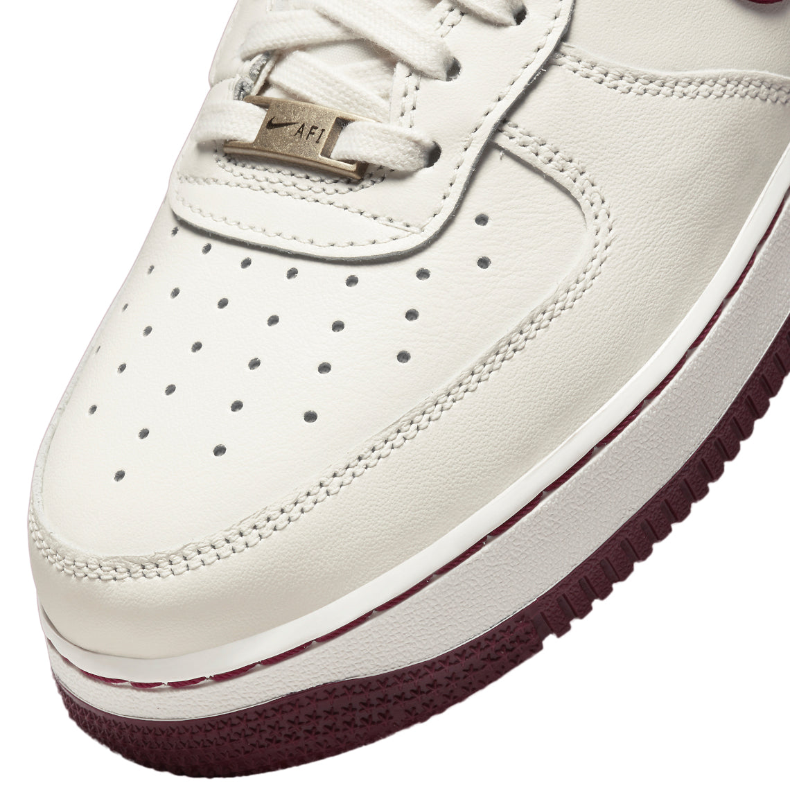 Toe and lace close-up of sail leather sneakers with dark beetroot trim and perforations