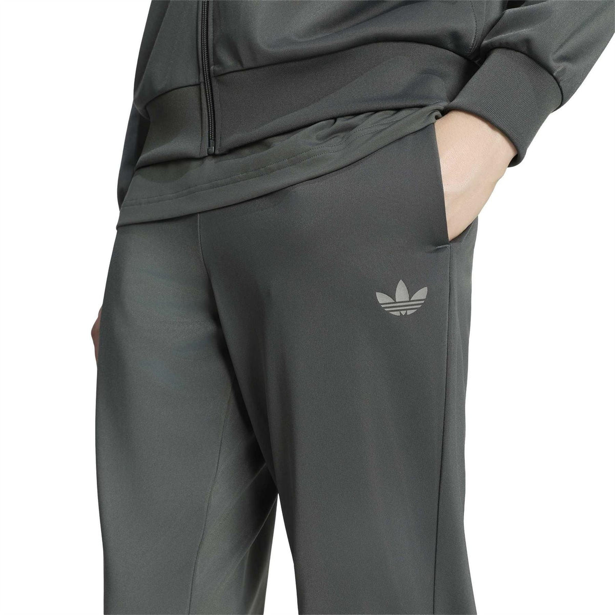 Close-up of dark green jogger pants with side logo and zippered jacket hem