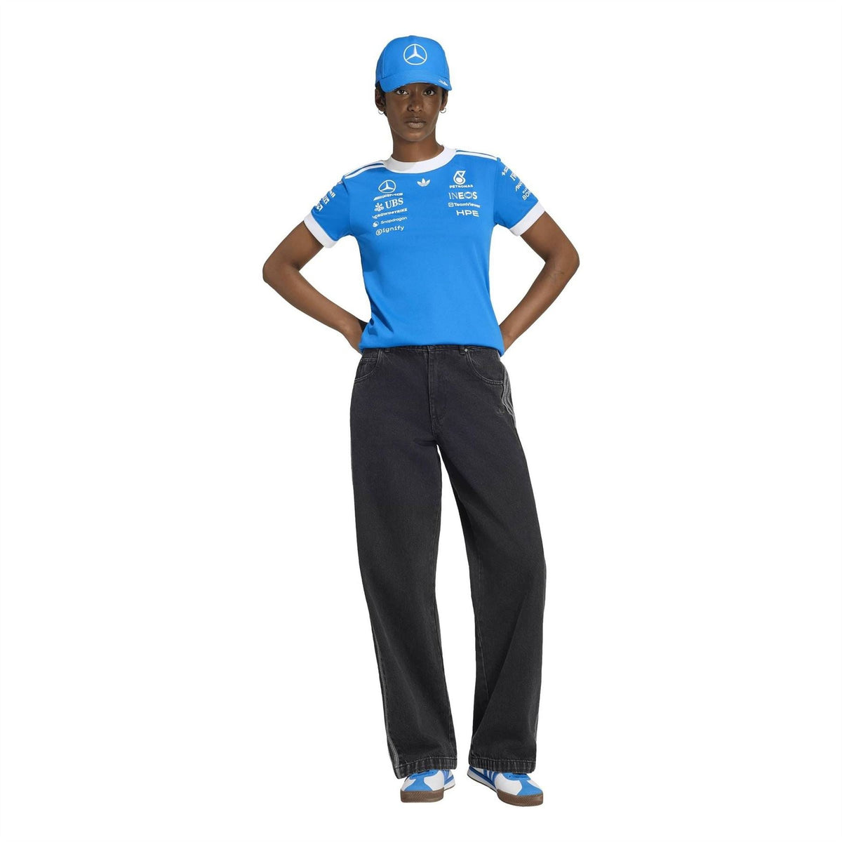 Blue crew-neck short-sleeve jersey with white trim, styled with dark pants