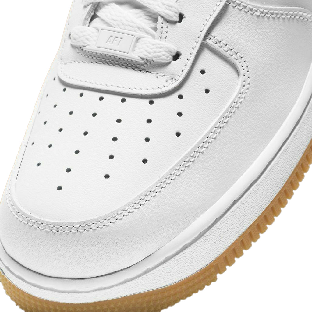 Nike Air Force 1 forefoot close-up with white perforations and gum outsole edge