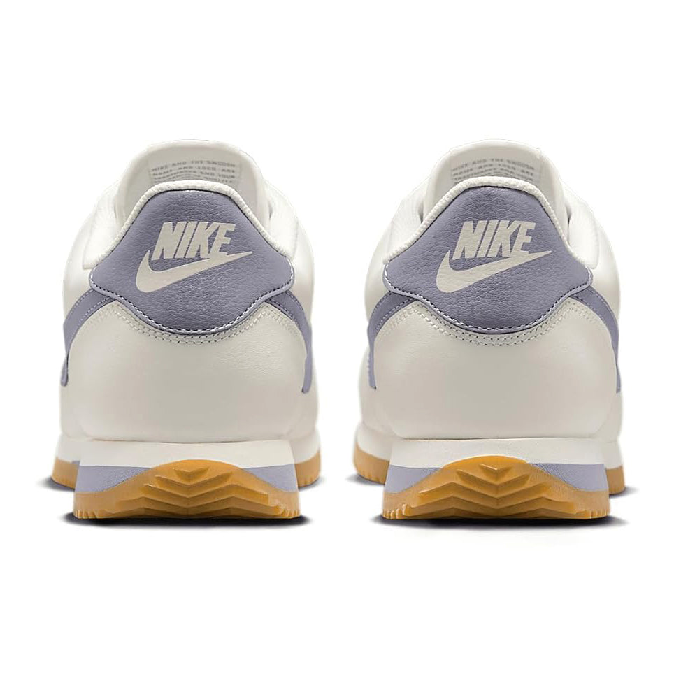Men's Nike Cortez sneakers, white heel with navy NIKE tab and gum rubber sole.