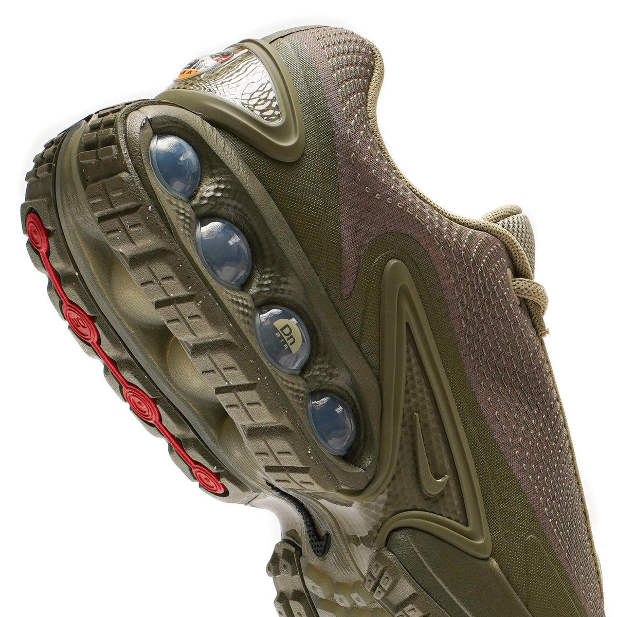 Nike Air Max DN outsole close-up in olive with circular grip pods
