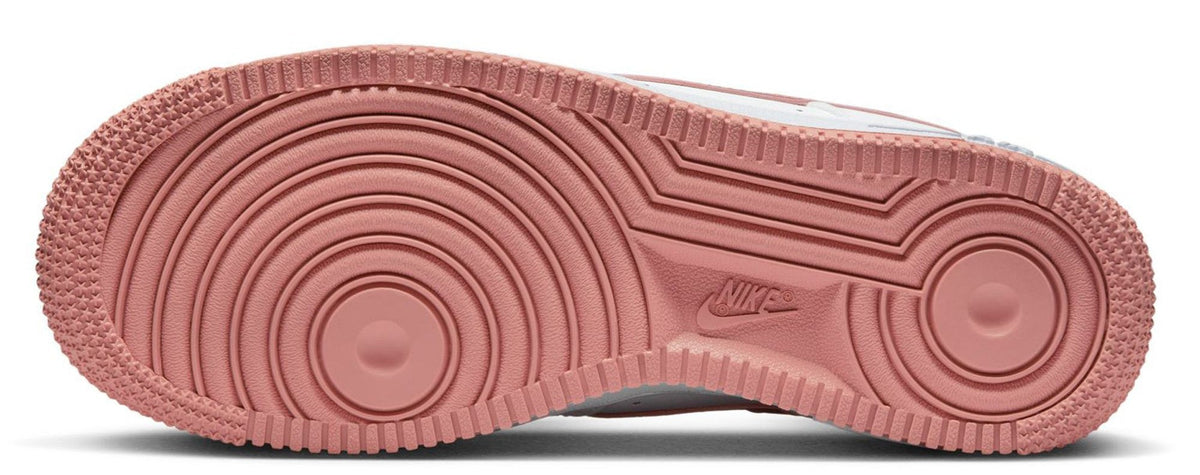 Kids' Nike low-top sneakers: pink/red outsole with circular tread pattern