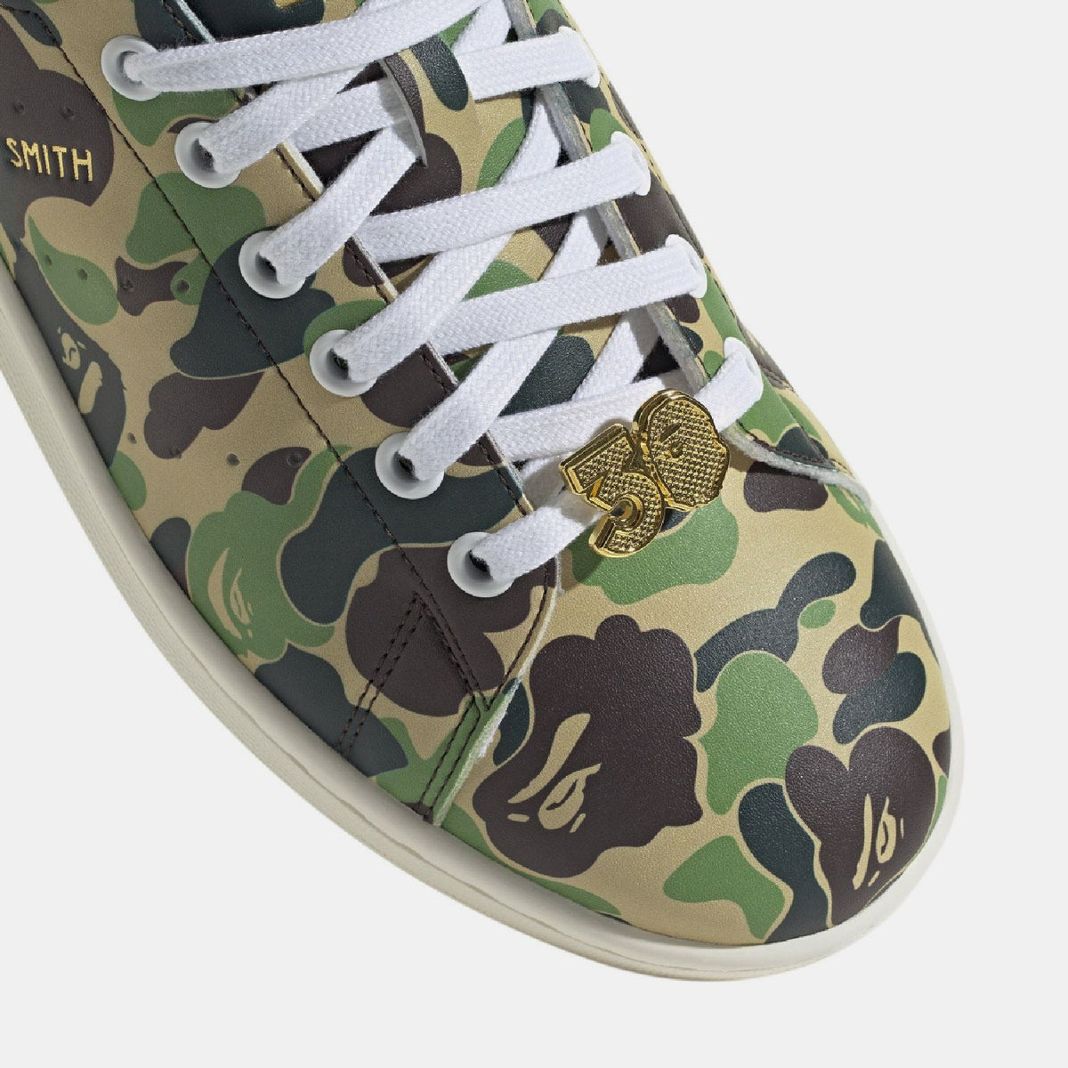 adidas Originals Bape Stan Smith shoes featuring classic white leather with Bape camo accents and green heel tab, casual footwear.