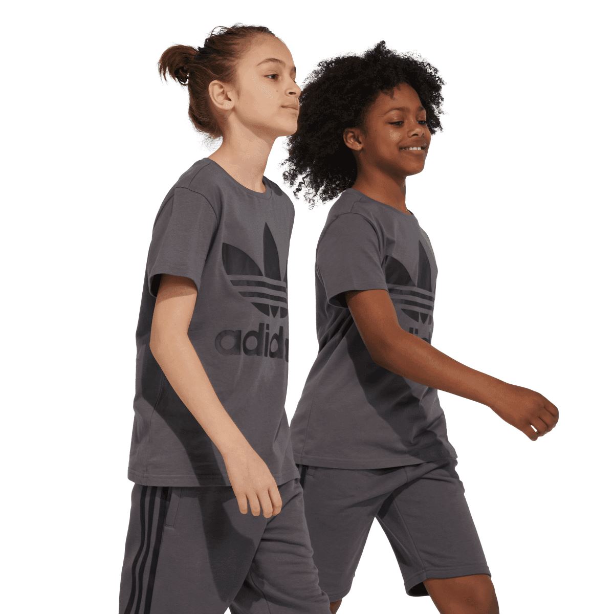 Grey junior T-shirt worn by kids, front view with adidas Trefoil graphic and stripes.