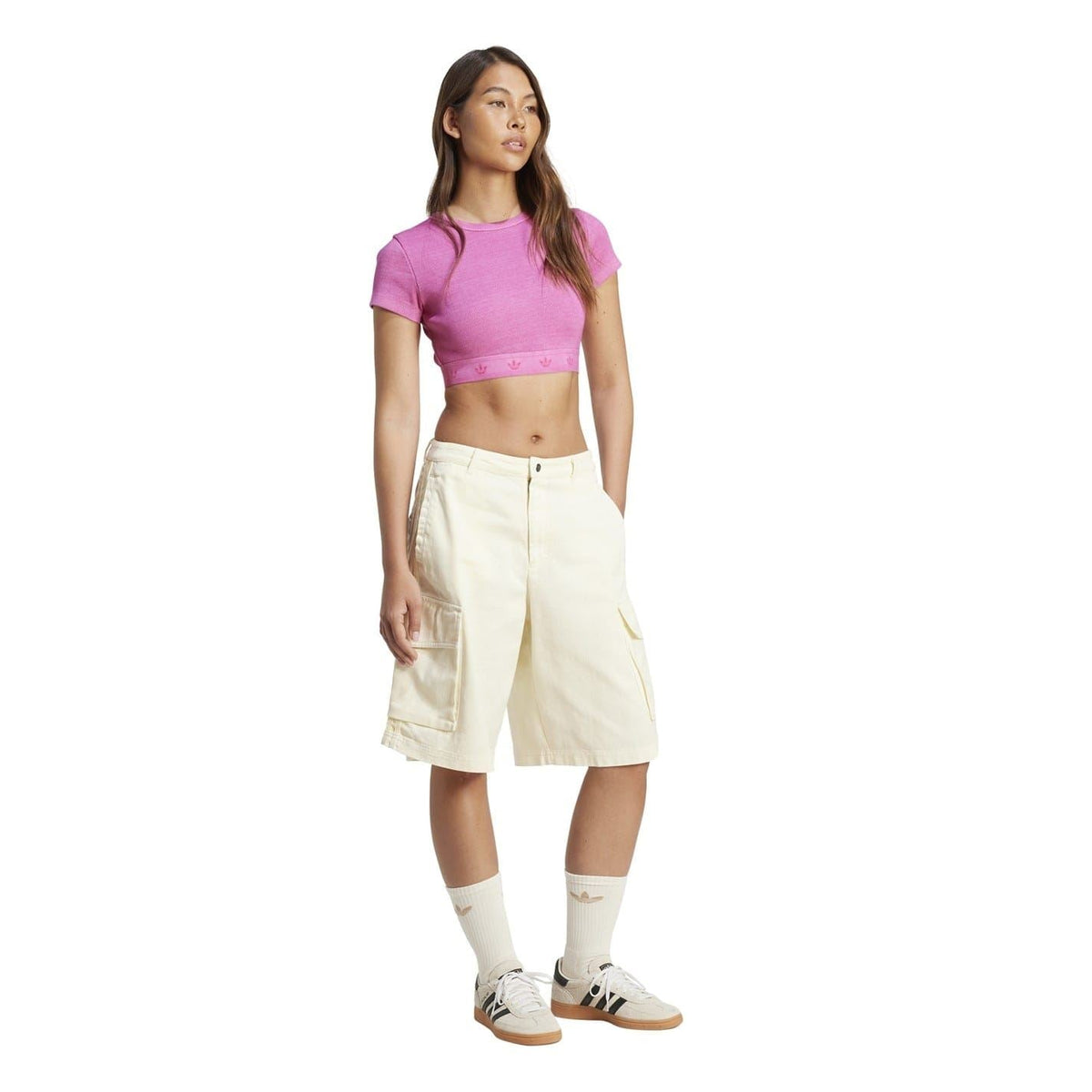 Cream white denim cargo shorts worn with socks and sneakers, relaxed baggy fit