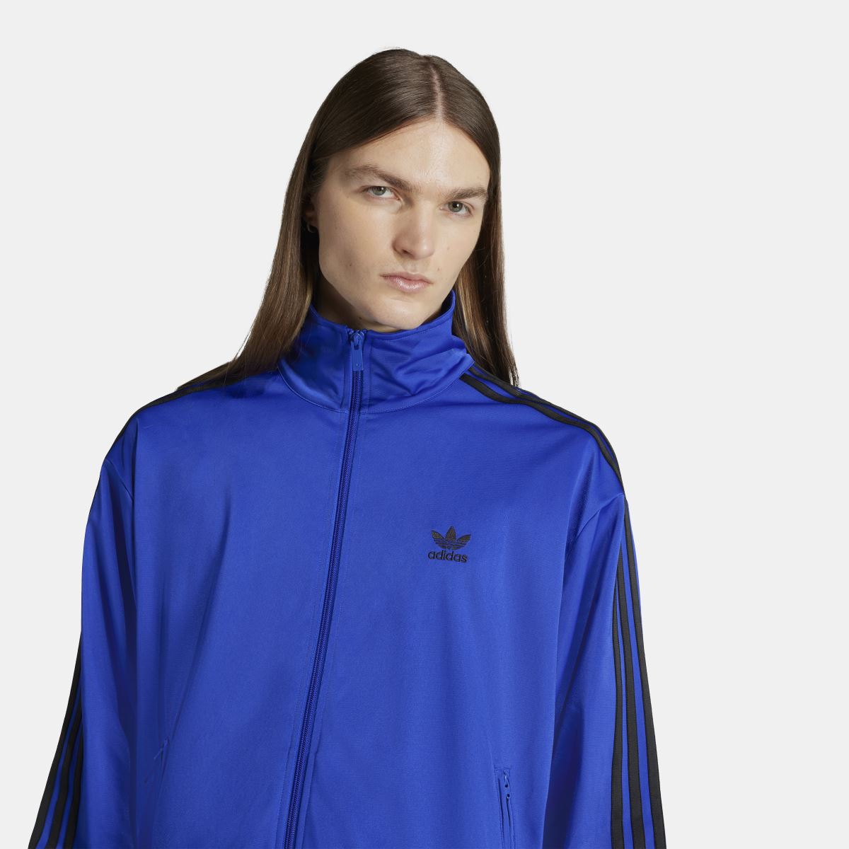 Blue adidas track jacket detail with front full zip and adidas logo on chest